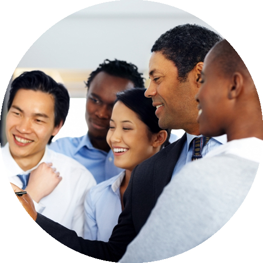 Multi-racial group of happy business professionals work at a white board