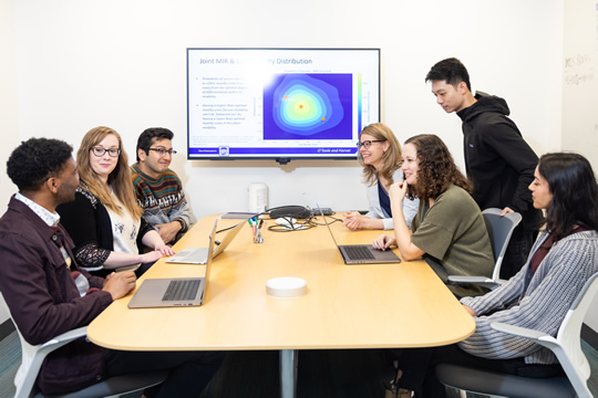 students around a table collaborating on a project