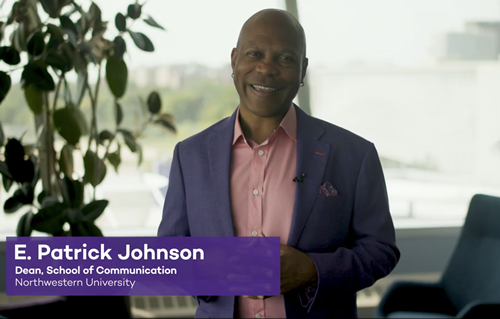 Dean Johnson in purple coat smiles