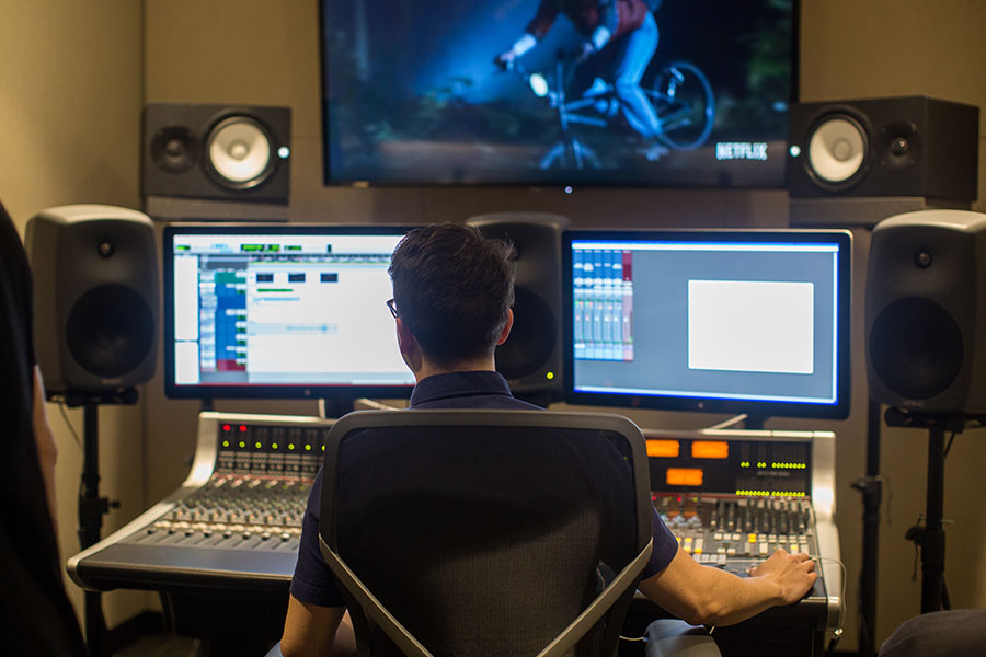 Person in media production booth