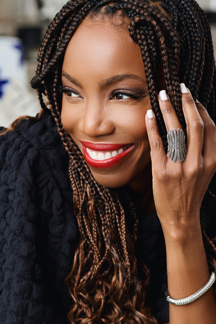 Heather Headley smiles and looks to her side